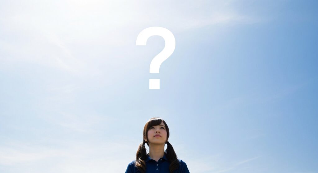 疑問に思っている女性の介護職員の画像