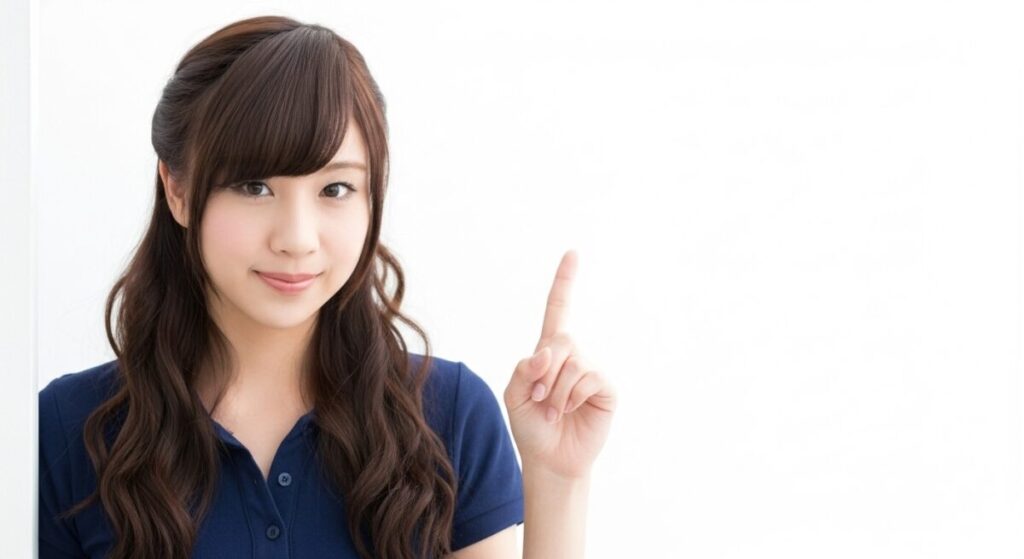 若い女性介護職員が人差し指を立ててこちらを見ている。介護現場のポイントや提案を示すイメージ。